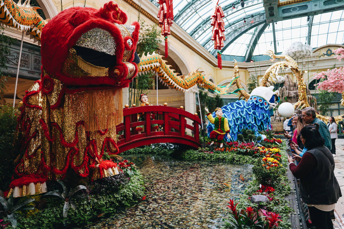 Visitors take in a Chinese New Year themed display at the Bellagio Conservatory and Botanical G ...