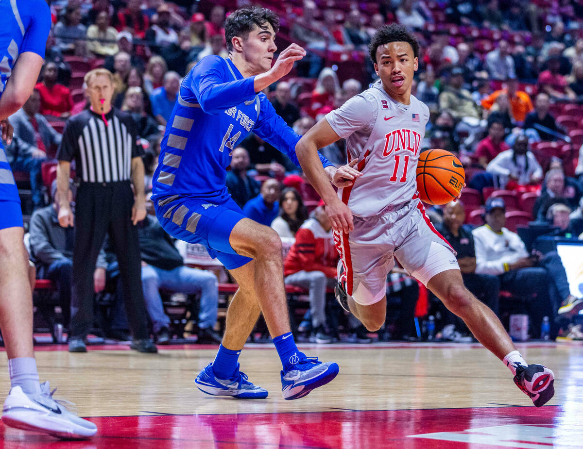 UNLV guard Dedan Thomas Jr. (11) looks to drive the lane against Air Force Falcons forward Beau ...