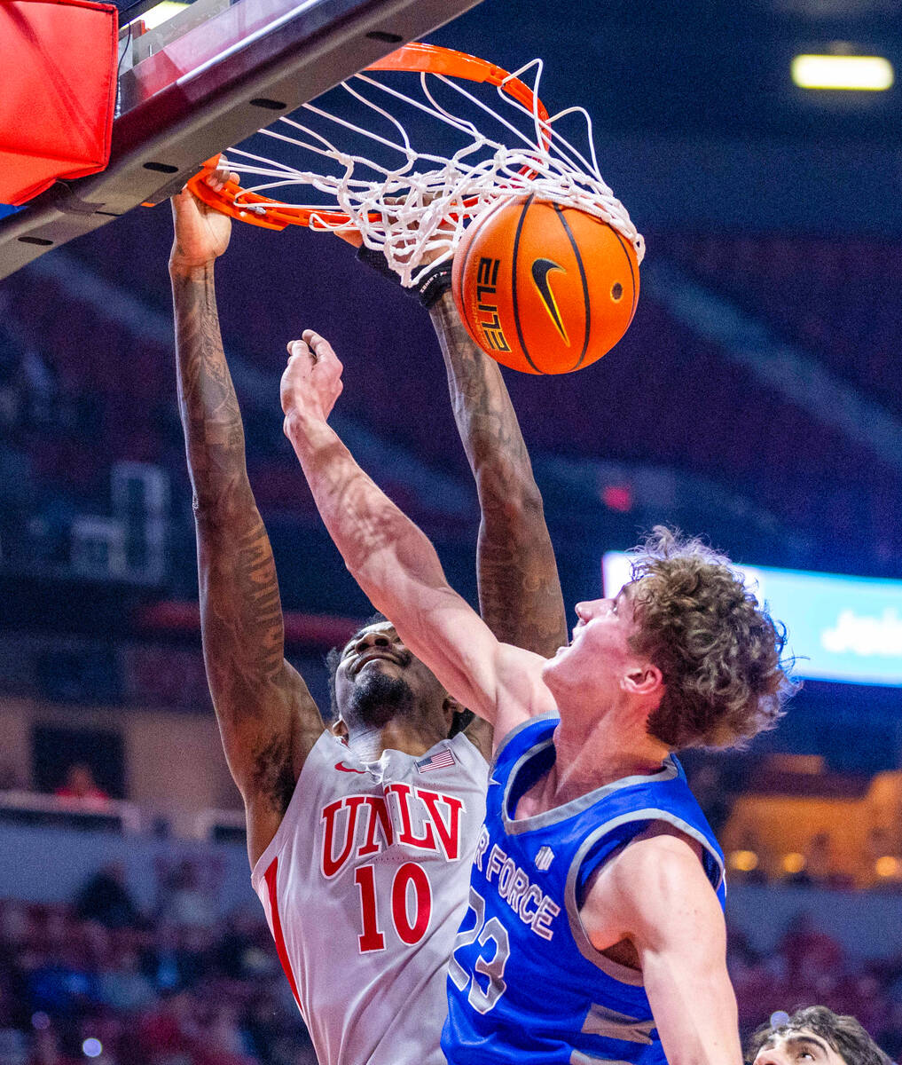 UNLV forward Kalib Boone (10) dunks the ball over Air Force Falcons guard Kellan Boylan (23) du ...