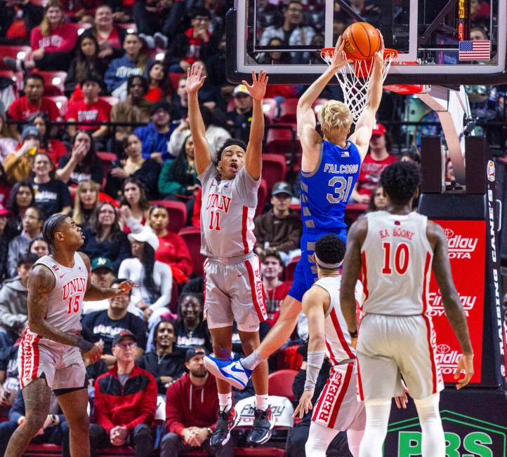 UNLV guard Dedan Thomas Jr. (11) elevates to help defend the net from Air Force Falcons forward ...