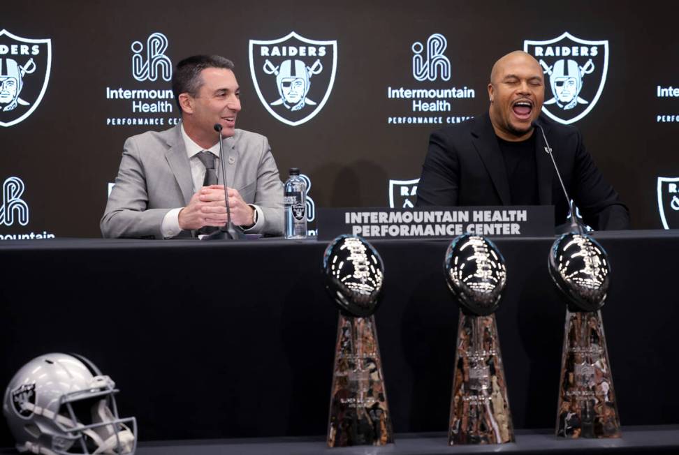 Raiders coach Antonio Pierce, right, chants, “Raiders!” as general manager Tom Te ...