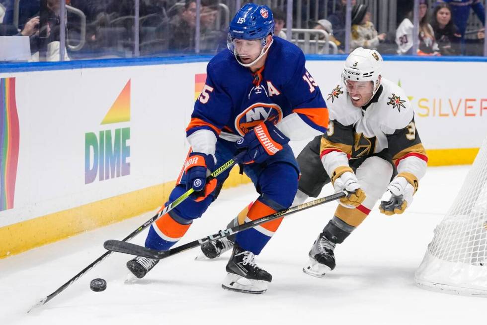 Vegas Golden Knights' Brayden McNabb (3) fights for control of the puck with New York Islanders ...