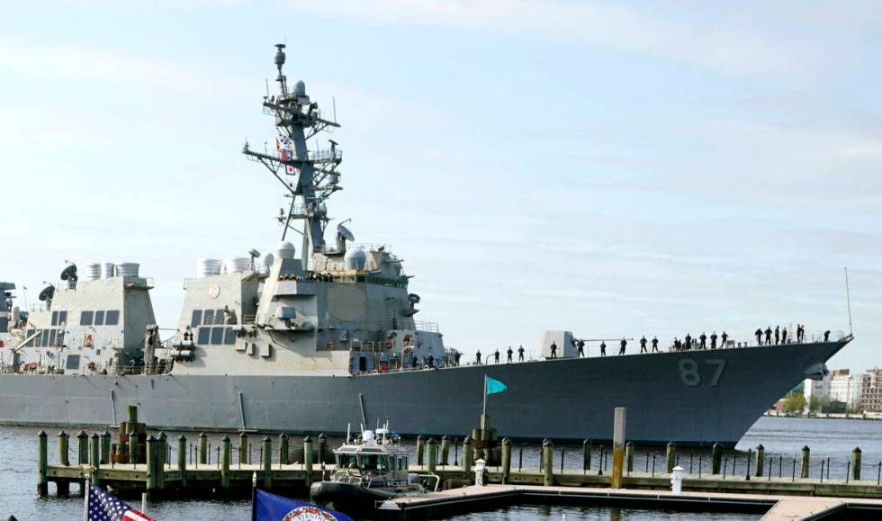 File - The USS Mason, an Arleigh Burke-class destroyer, passes a dock in Norfolk, Va., April 8, ...