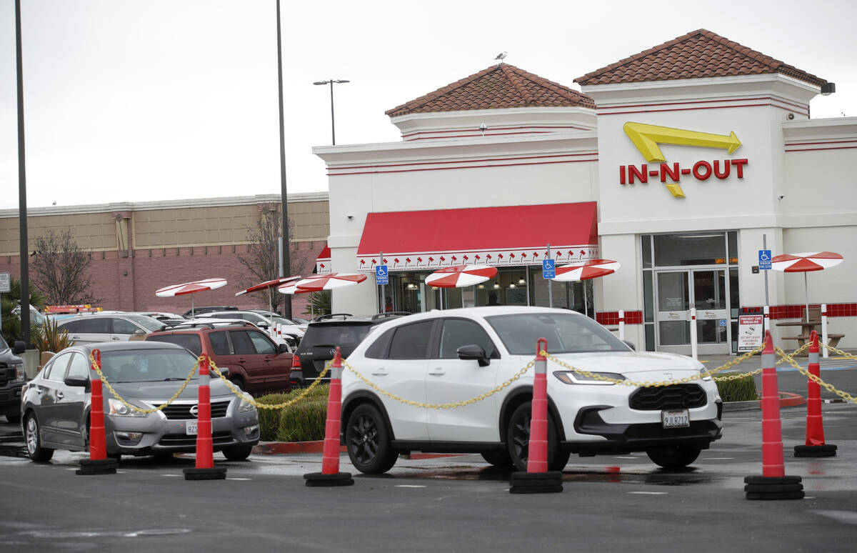 Customers line up at the In-N-Out drive-thru off Hegenberger Road in Oakland, Calif., on Monday ...