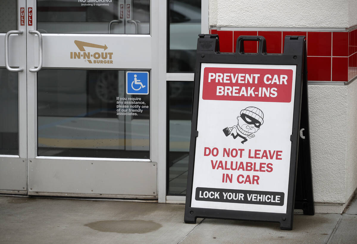 A sign warns patrons of car break-ins at the In-N-Out restaurant off Hegenberger Road in Oaklan ...