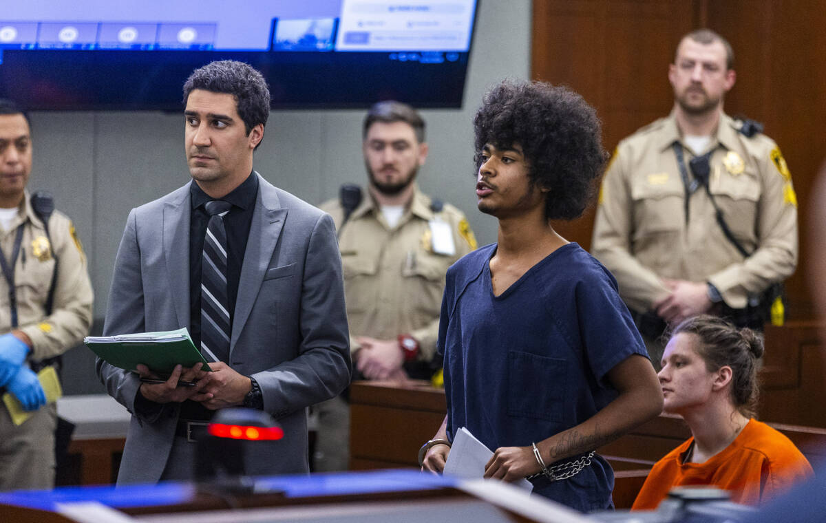 Defendant Treavion Randolph, center, stands with his attorney while answering questions by Judg ...