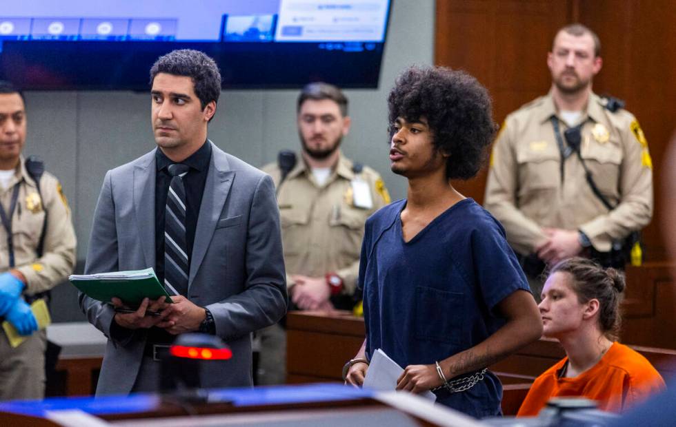 Defendant Treavion Randolph, center, stands with his attorney while answering questions by Judg ...