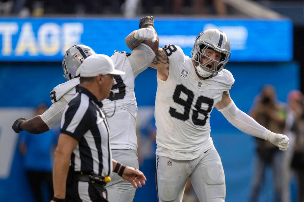 Raiders defensive end Maxx Crosby (98) celebrates a sack of Los Angeles Chargers quarterback Ju ...