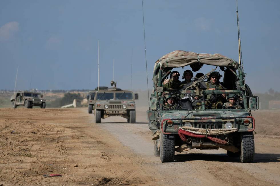 Israeli forces move near the Gaza Strip border in southern Israel, Thursday, Jan. 25, 2024. The ...