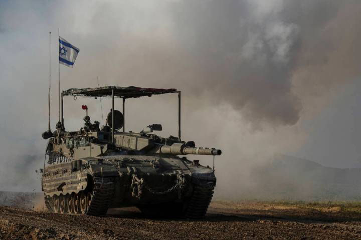 An Israeli army tank moves near the Gaza Strip border, in southern Israel, Wednesday, Jan. 24, ...