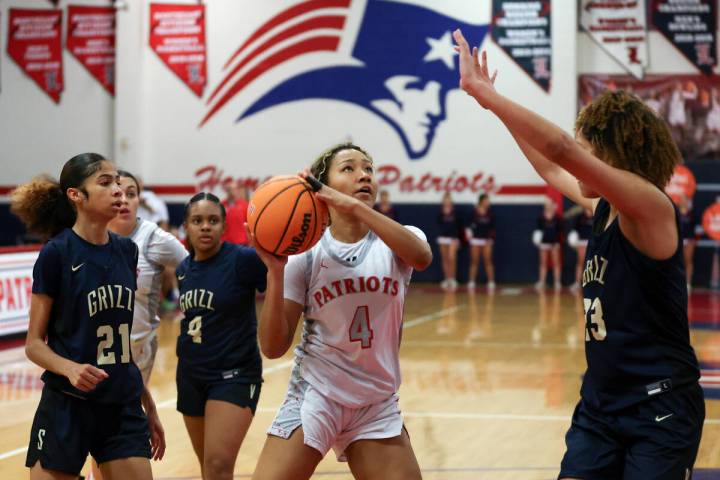 Liberty's Satsuki Bradley (4) shoots against Spring Valley's Jada Green (23) during the first h ...