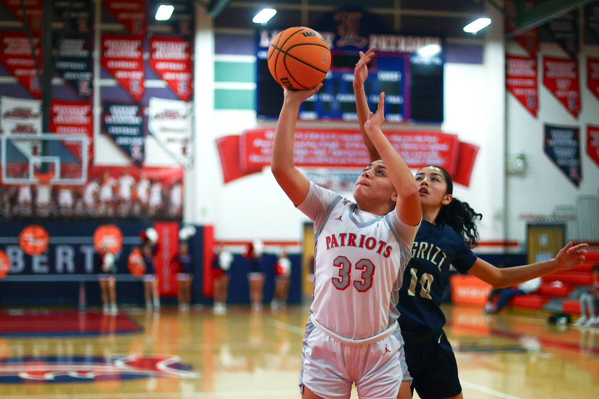 Liberty's Leiliani Harworth (33) shoots against Spring Valley's Melanie Ortiz (10) during the f ...
