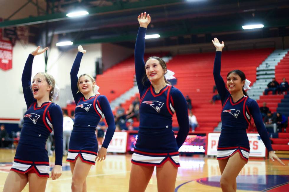 Liberty cheerleaders pump up the crowd during the second half of a high school basketball game ...