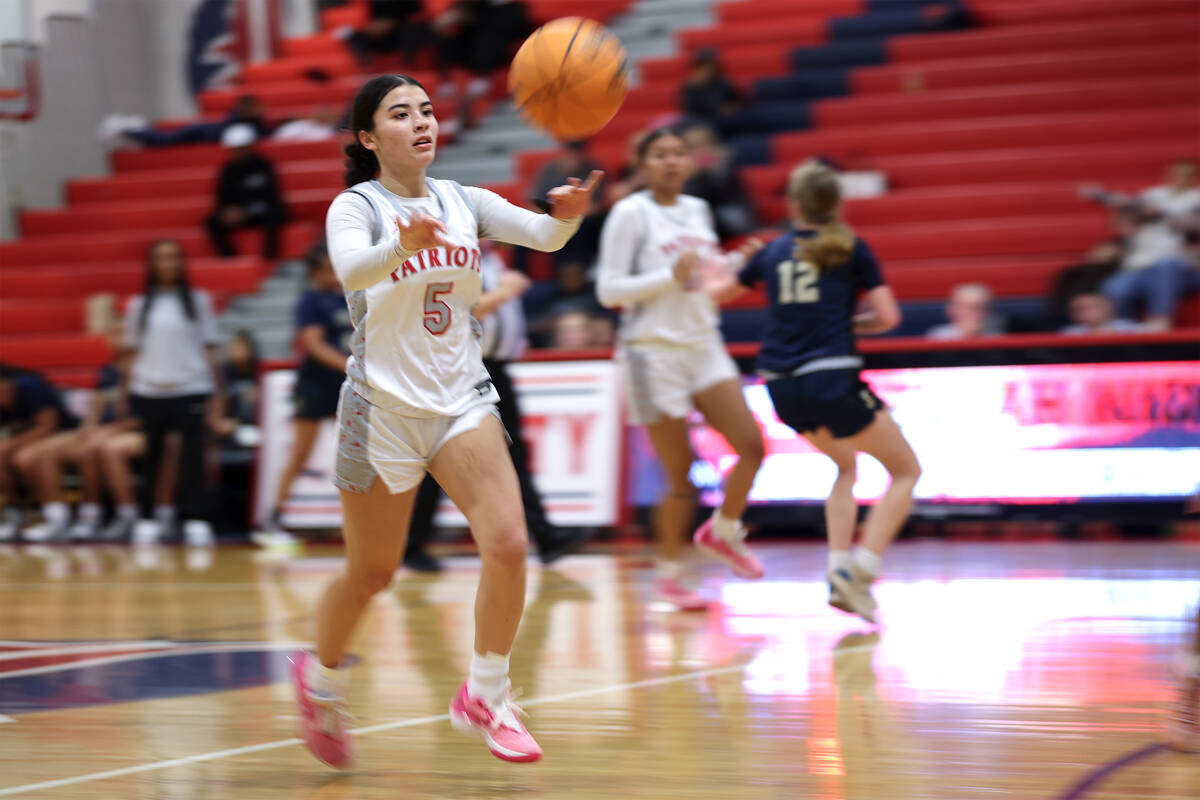 Liberty's Samantha Chesnut (5) passes up the court during the second half of a high school bask ...