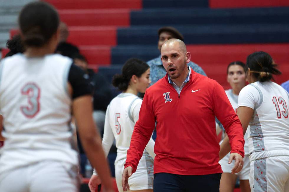 Liberty's head coach Billy Hemberger brings his team in for a timeout during the second half of ...
