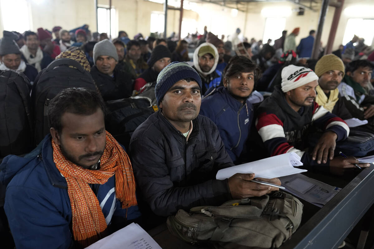 Indian workers aspiring to be hired for jobs in Israel wait to submit their forms during a recr ...