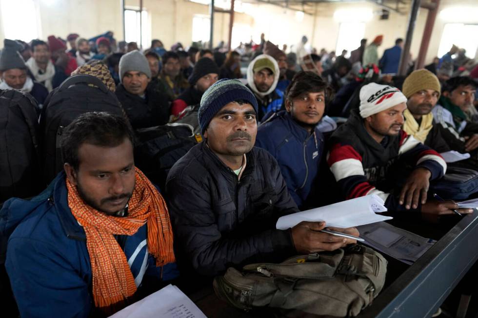 Indian workers aspiring to be hired for jobs in Israel wait to submit their forms during a recr ...
