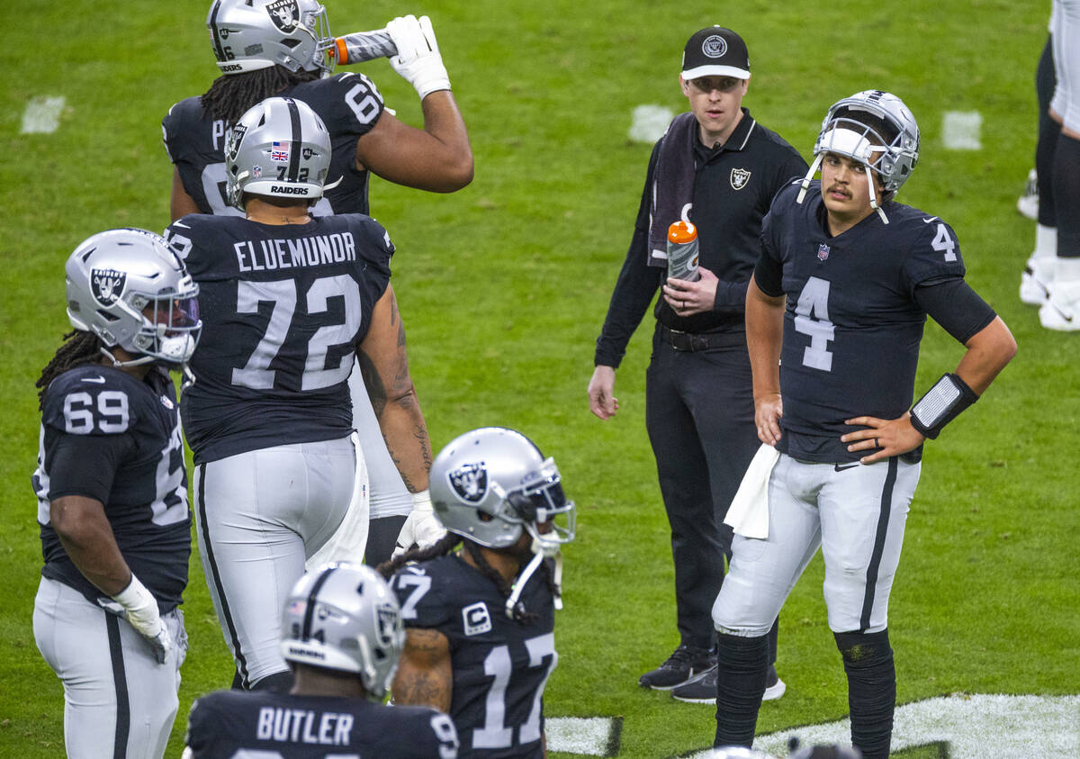 Raiders quarterback Aidan O'Connell (4) is a bit dismayed during a timeout against the Denver B ...