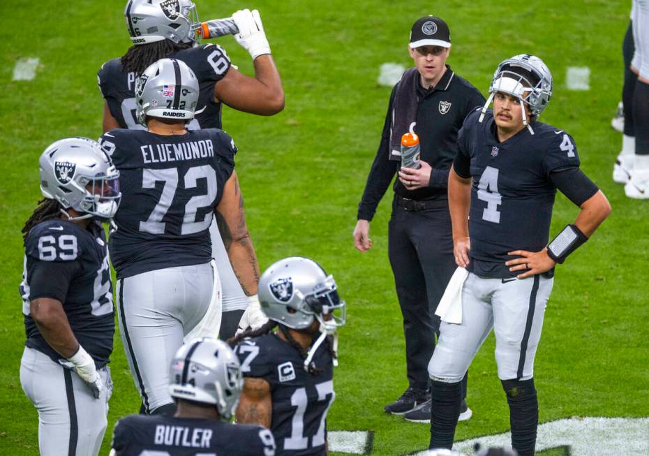 Raiders quarterback Aidan O'Connell (4) is a bit dismayed during a timeout against the Denver B ...