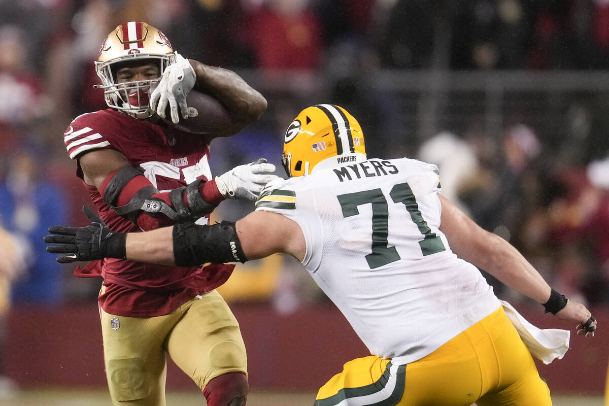 San Francisco 49ers linebacker Dre Greenlaw (57) intercepts a pass next to Green Bay Packers ce ...