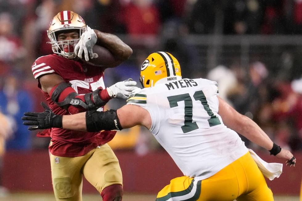San Francisco 49ers linebacker Dre Greenlaw (57) intercepts a pass next to Green Bay Packers ce ...