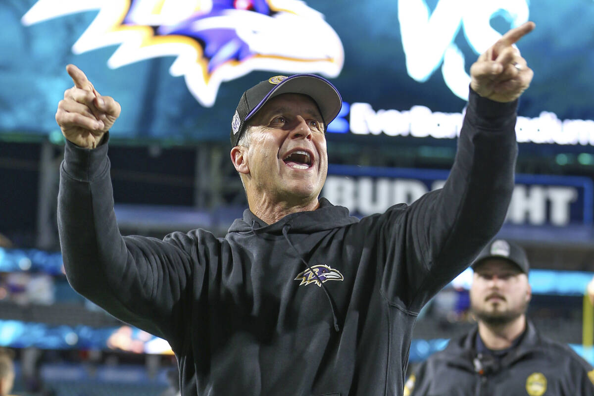 FILE - Baltimore Ravens head coach John Harbaugh reacts to fans as he walks off the field after ...