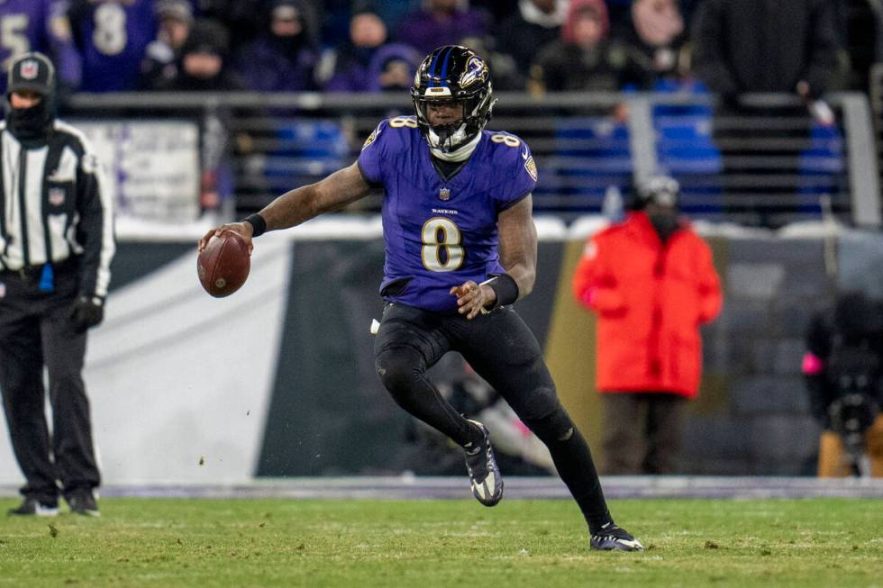 Baltimore Ravens quarterback Lamar Jackson runs with the ball against the Houston Texans during ...