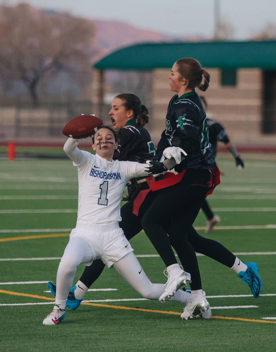 Bishop Gorman wide receiver Olivia Cobell falls as her flag is snatched during a flag football ...