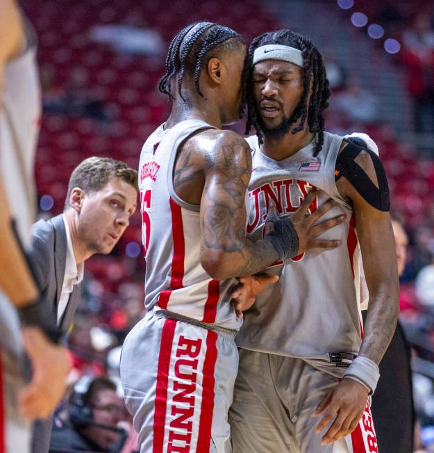 UNLV guard Luis Rodriguez (15) attempts to calm down forward Keylan Boone (20) frustrated by th ...