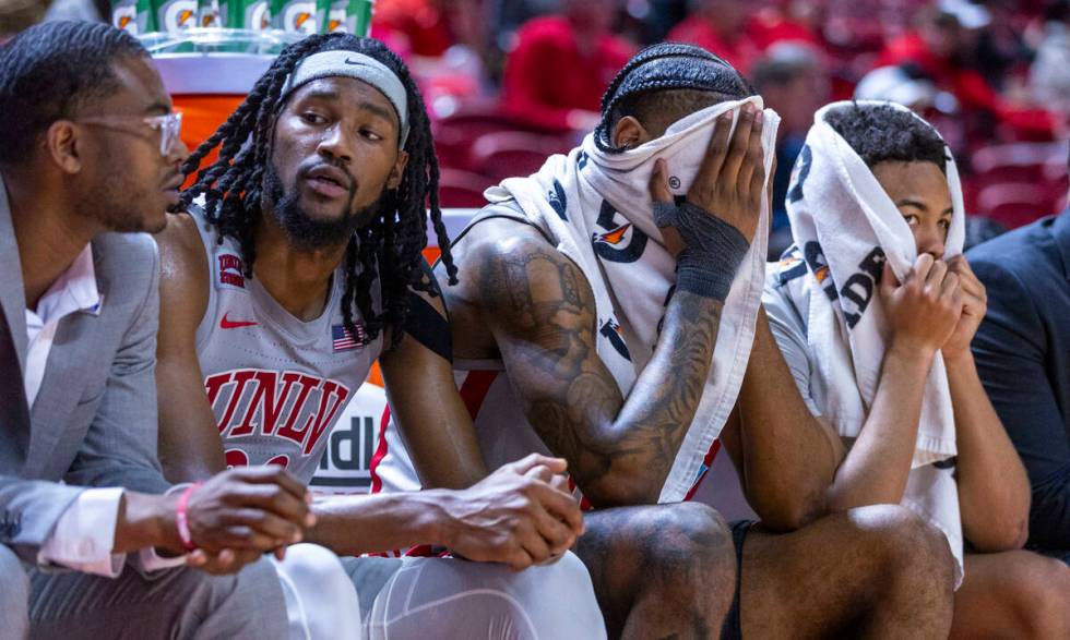 UNLV forward Keylan Boone (20), guard Luis Rodriguez (15) and guard Dedan Thomas Jr. (11) are d ...