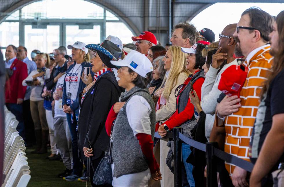 Supporters sing the National Anthem before Republican presidential candidate former President D ...