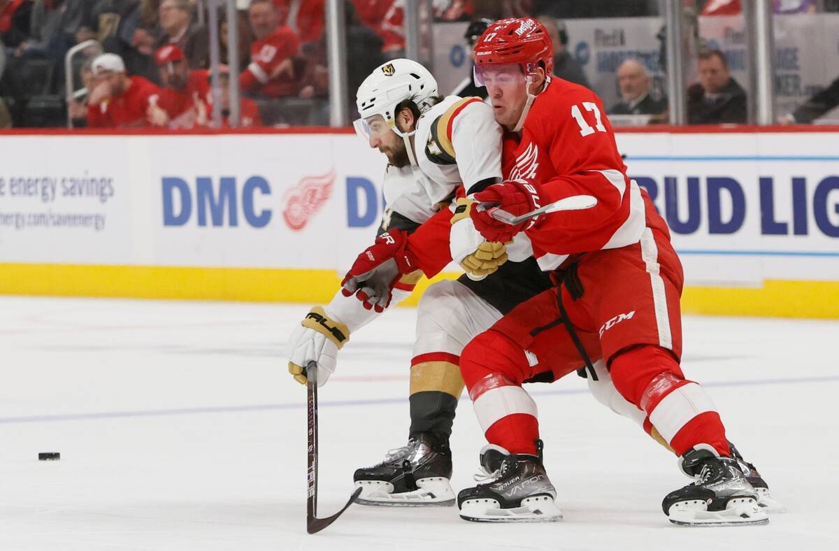 Vegas Golden Knights defenseman Nicolas Hague, left, becomes entangled with Detroit Red Wings r ...