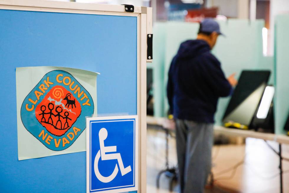 Eliseo Flores casts his vote during the early voting period at Seafood City Market on Saturday, ...