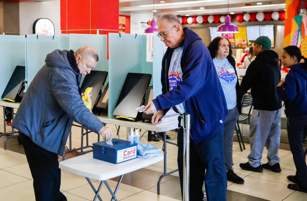 A voter finishes the voting process during the early voting period at Seafood City Market on Sa ...