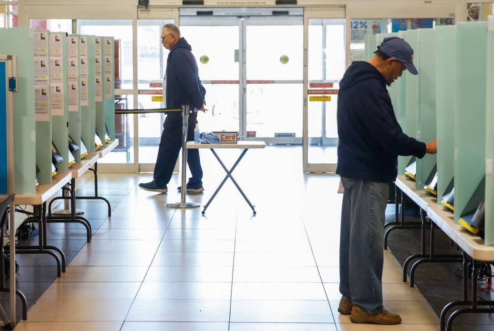 Eliseo Flores casts his vote during the early voting period at Seafood City Market on Saturday, ...