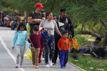 Migrants arrive to the Mexican side of the bank of the Rio Grande. (AP Photo/Fernando Llano)