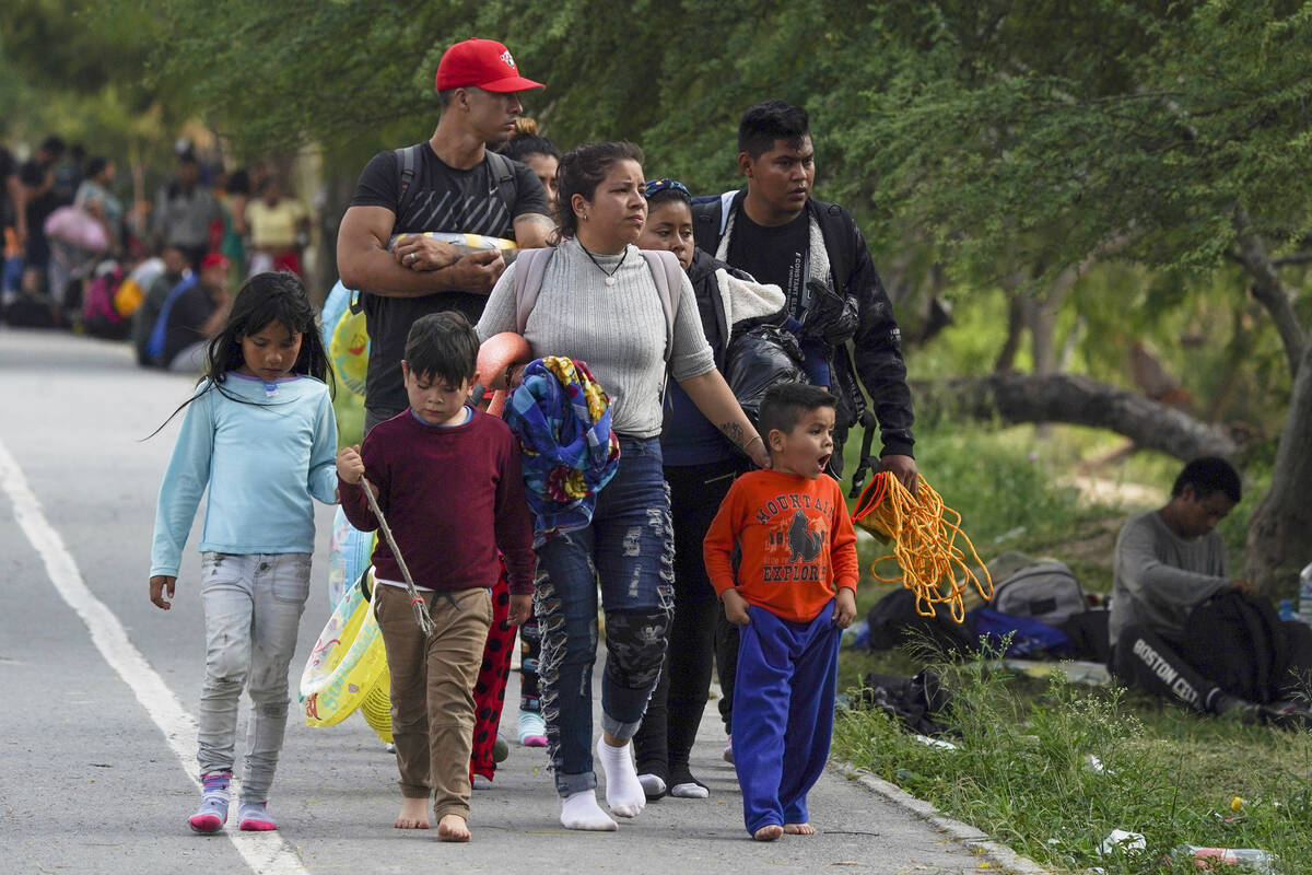 Migrants arrive to the Mexican side of the bank of the Rio Grande. (AP Photo/Fernando Llano)