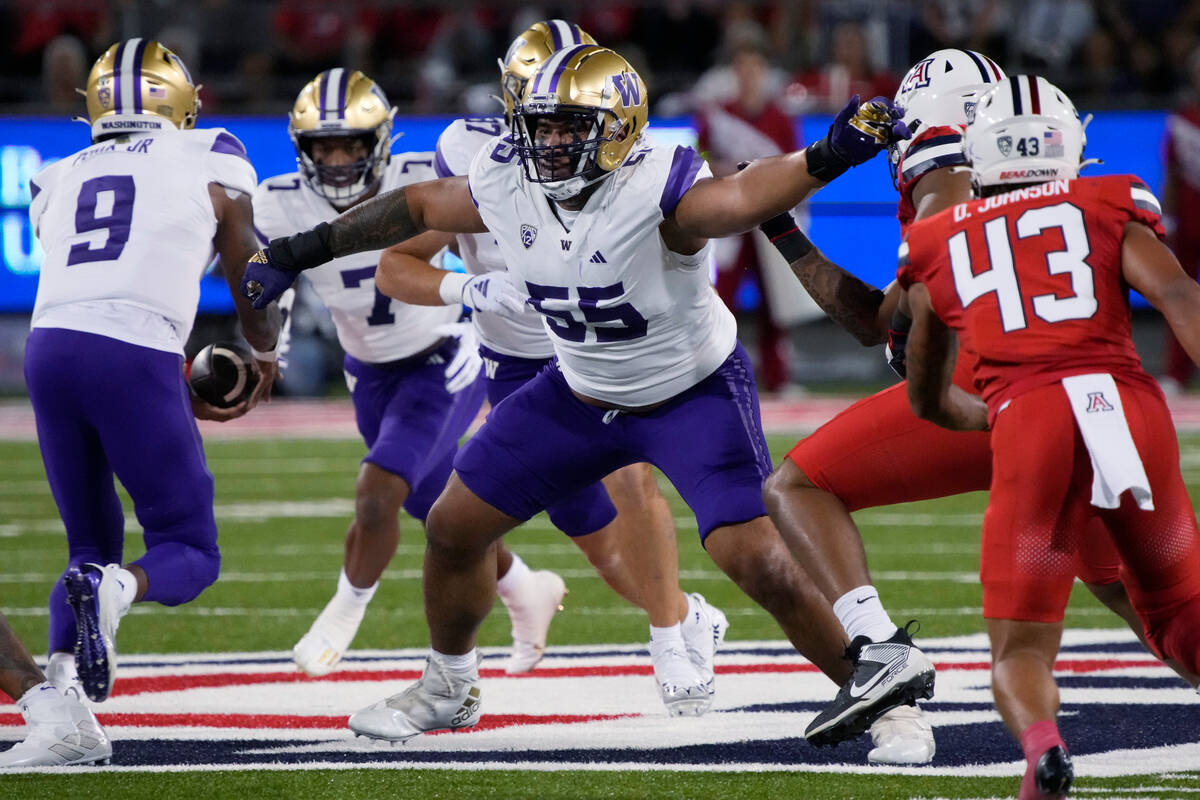 FILE - Washington offensive lineman Troy Fautanu (55) looks to block during the team's NCAA col ...