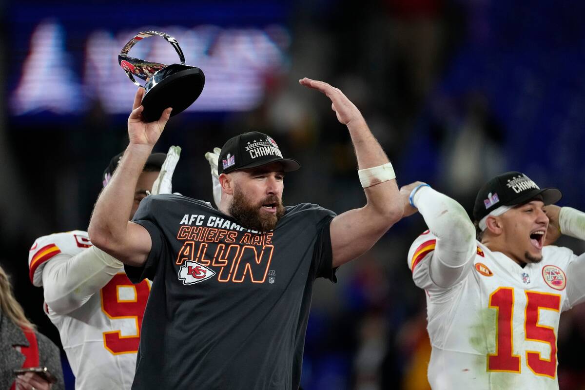 Kansas City Chiefs tight end Travis Kelce (87) holds a trophy after the AFC Championship NFL fo ...