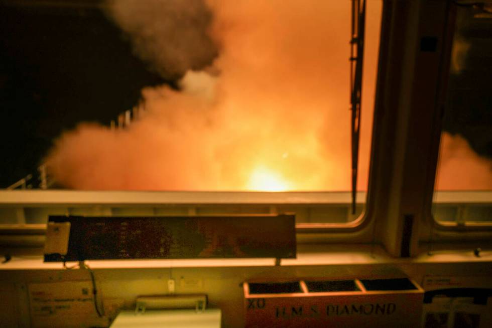 In this photo provided by the Royal Navy a view of HMS Diamond from the ships bridge, firing Se ...