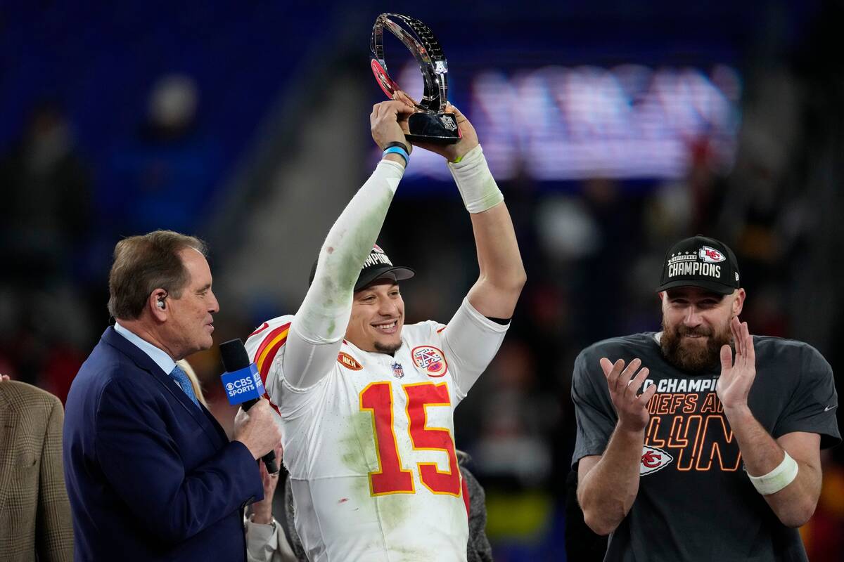 Kansas City Chiefs quarterback Patrick Mahomes (15) holds up the Lamar Hunt Trophy after the AF ...