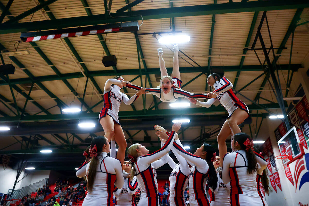 Liberty cheerleaders perform a stunt during the first half of a high school basketball game aga ...