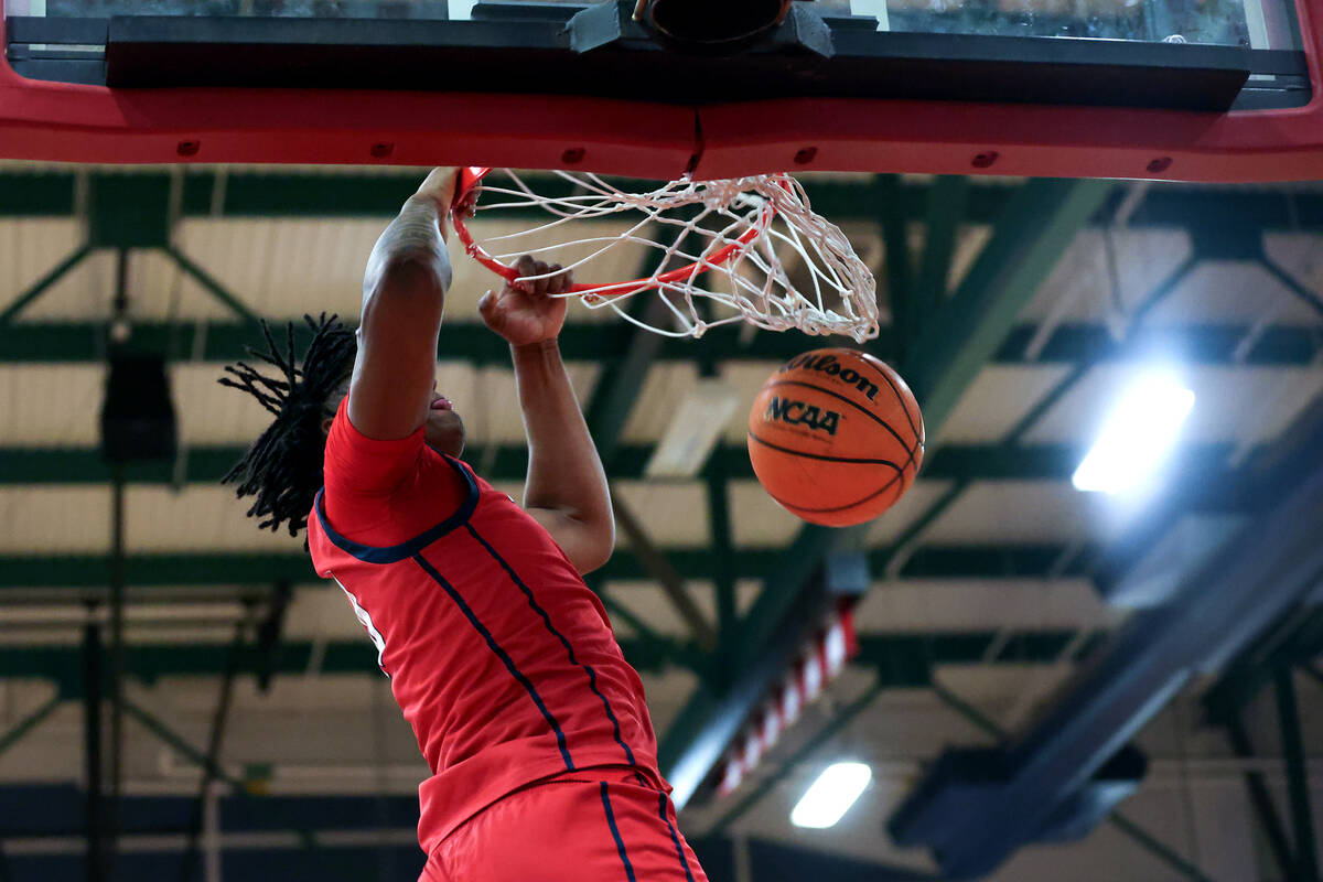 Coronado center Tee Bartlett (13) dunks during the second half of a high school basketball game ...