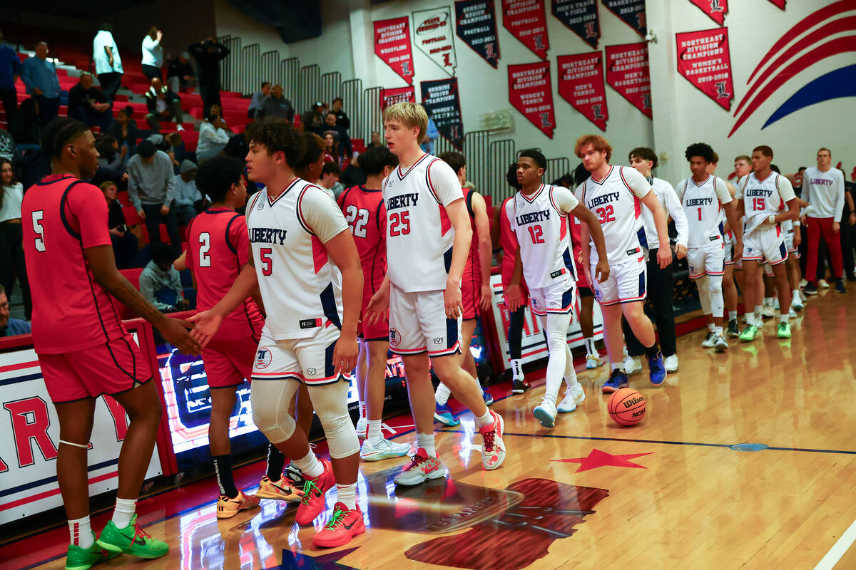 Liberty congratulates Coronado on their win in a high school basketball game at Liberty High Sc ...