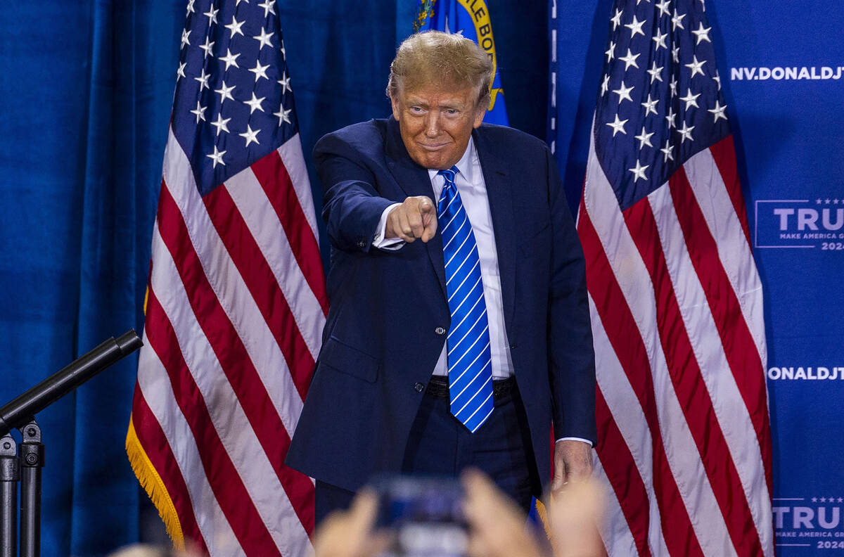 Republican presidential candidate former President Donald Trump points to the crowd while arriv ...