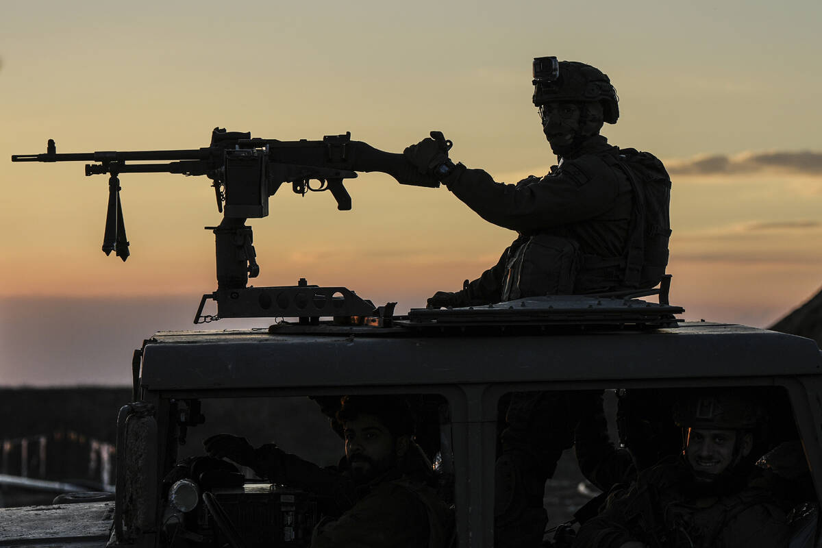 An Israeli soldier takes up position on the border with the Gaza Strip in southern Israel, Mond ...