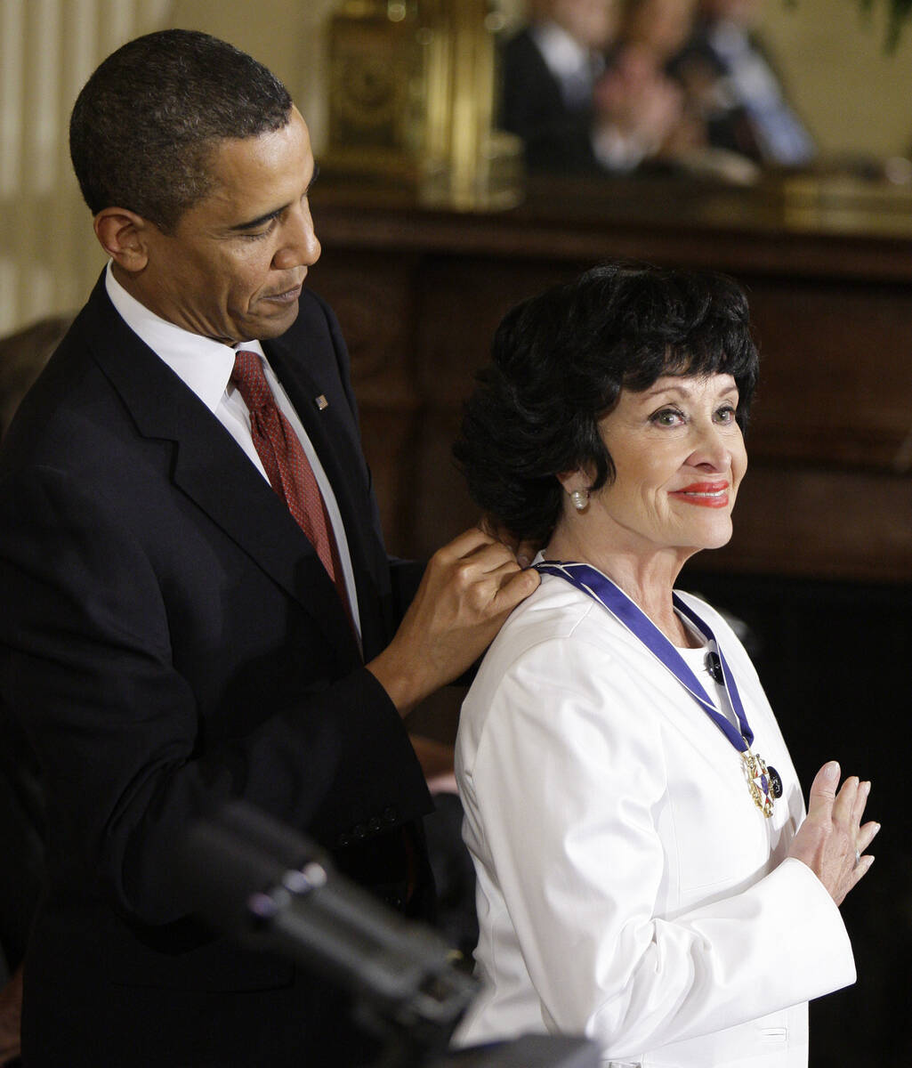 FILE - President Barack Obama places a 2009 Presidential Medal of Freedom around the neck of Ch ...