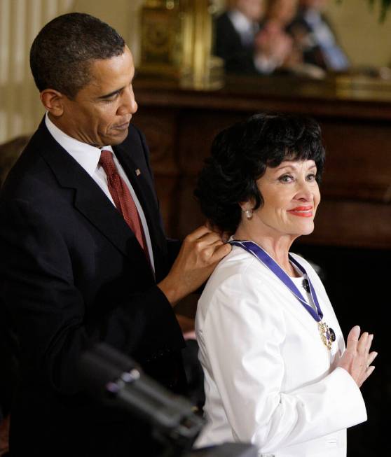 FILE - President Barack Obama places a 2009 Presidential Medal of Freedom around the neck of Ch ...