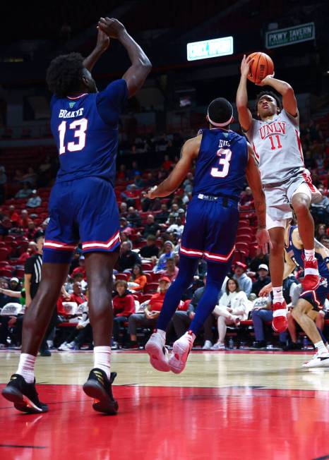 UNLV Rebels guard Dedan Thomas Jr. (11) shoots a jumper against Fresno State Bulldogs guard Isa ...