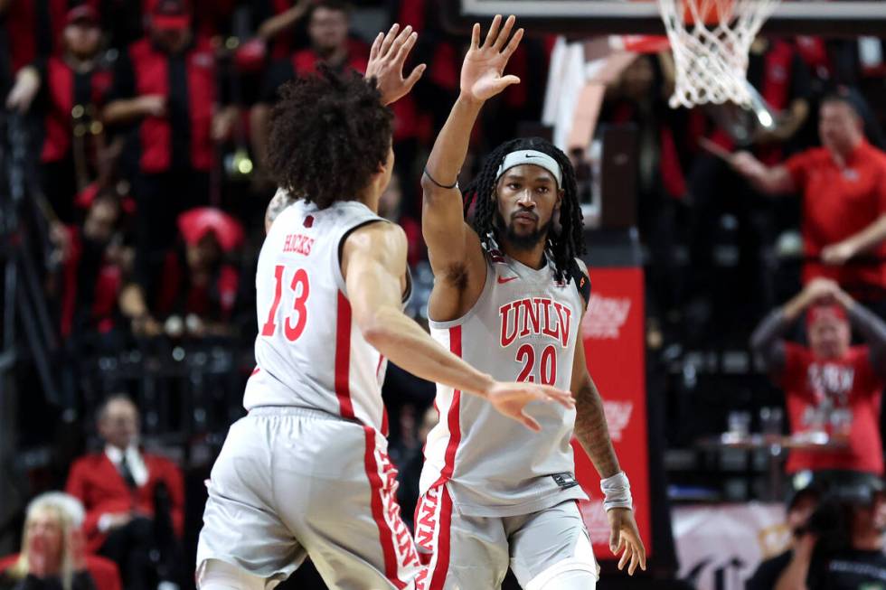 UNLV Rebels guard Brooklyn Hicks (13) slaps hands with forward Keylan Boone (20) during the sec ...